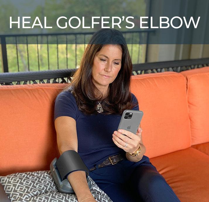 user wearing fiix elbow device. sitting on couch. heal golfer's elbow. user looking at phone