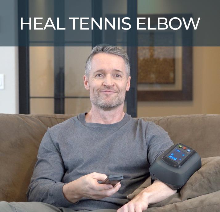 user wearing fiix elbow device. sitting on couch. heal tennis elbow. 